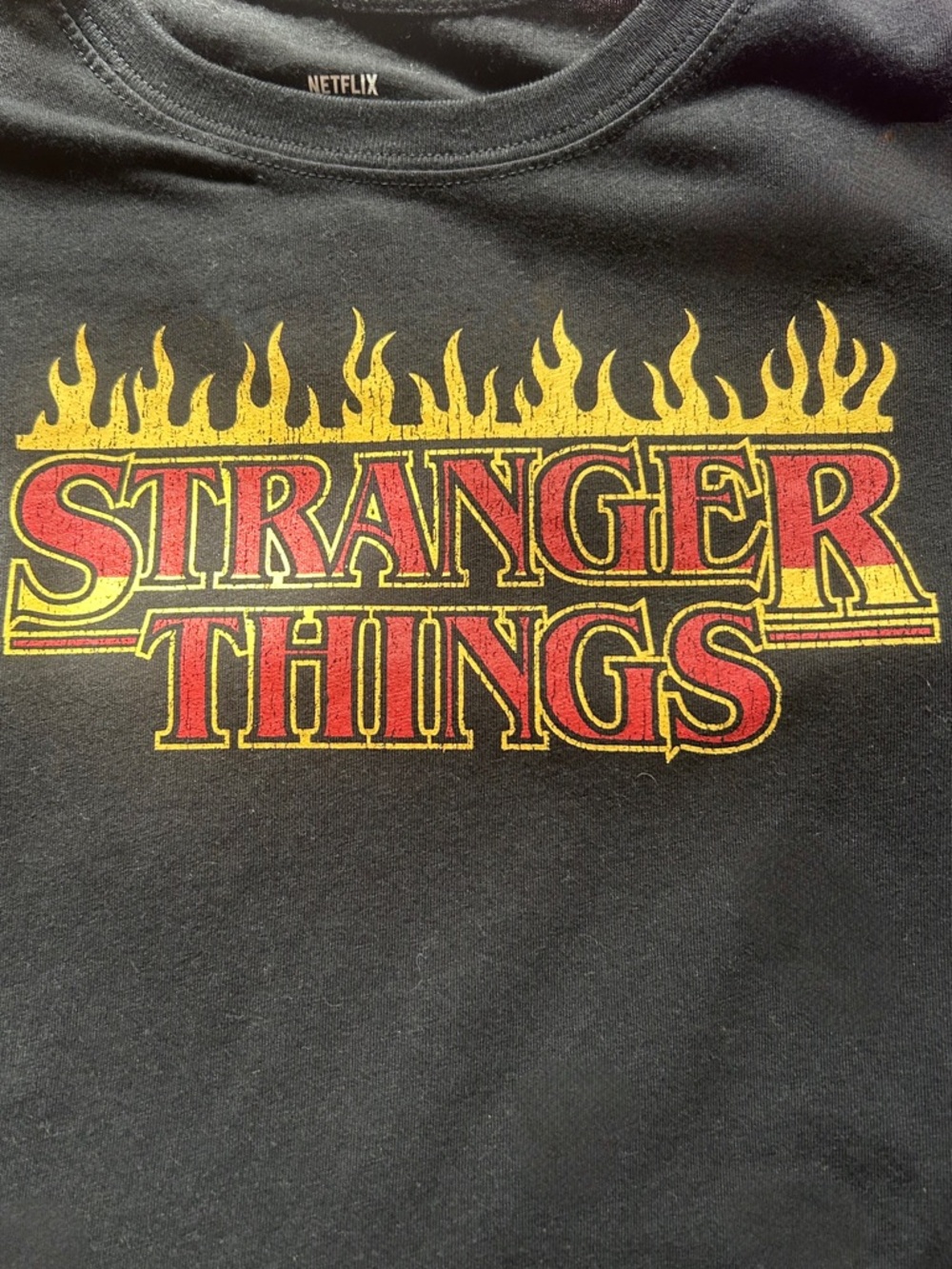 Netflix Kids Black Tee with Red and Yellow Stranger Things Flame Logo